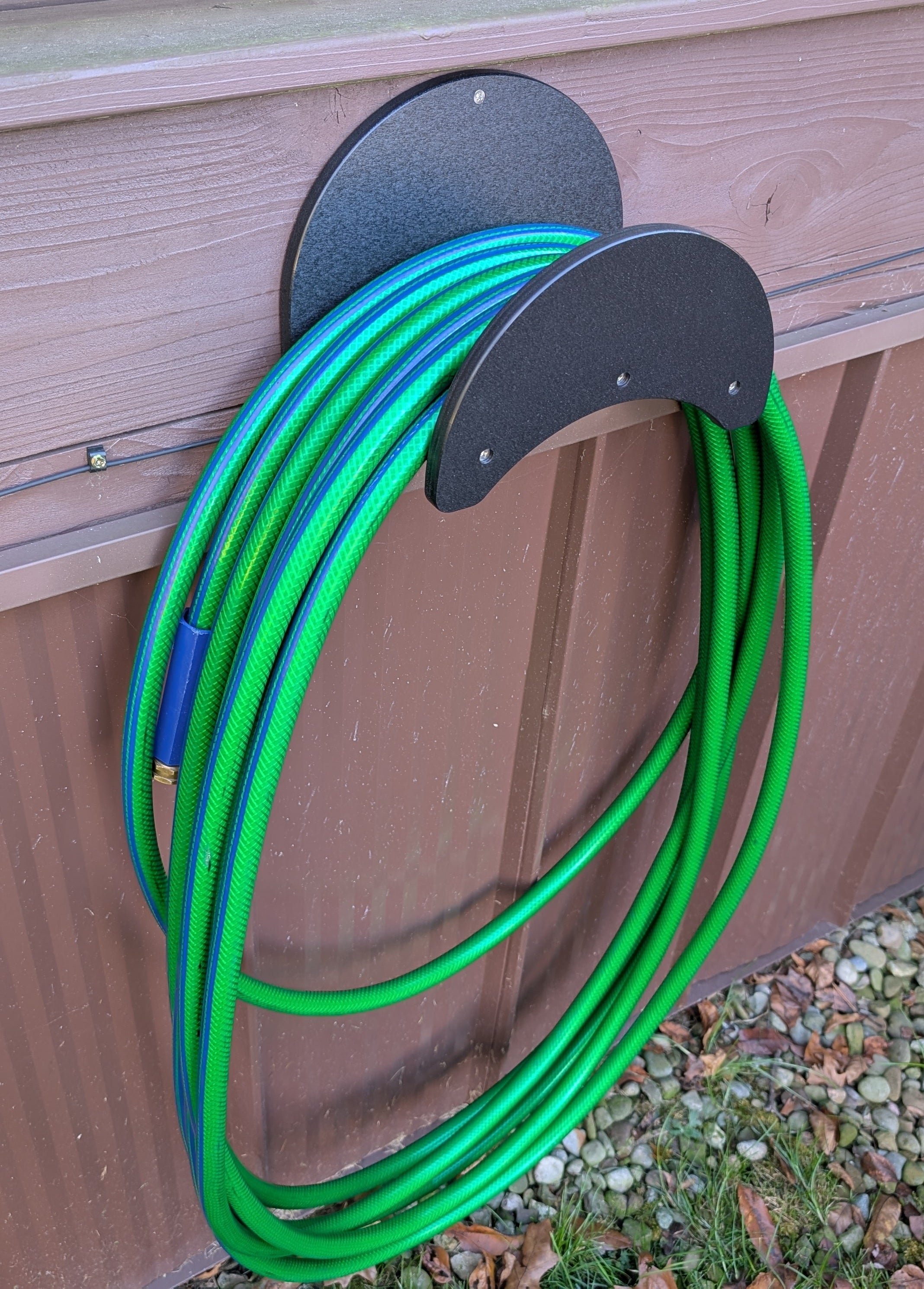 Heavy-duty poly outdoor wall-mount garden hose holder by Cauff, holds up to 150 ft