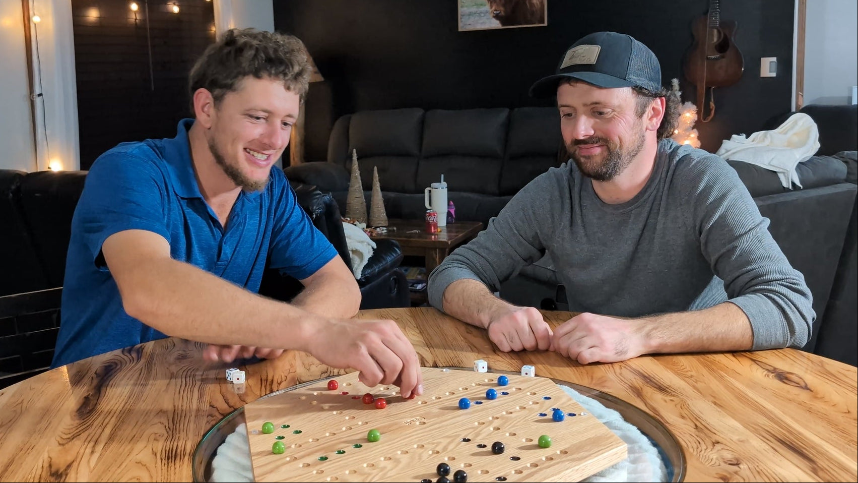 Cauff owners playing handcrafted hardwood games in a cozy home setting.