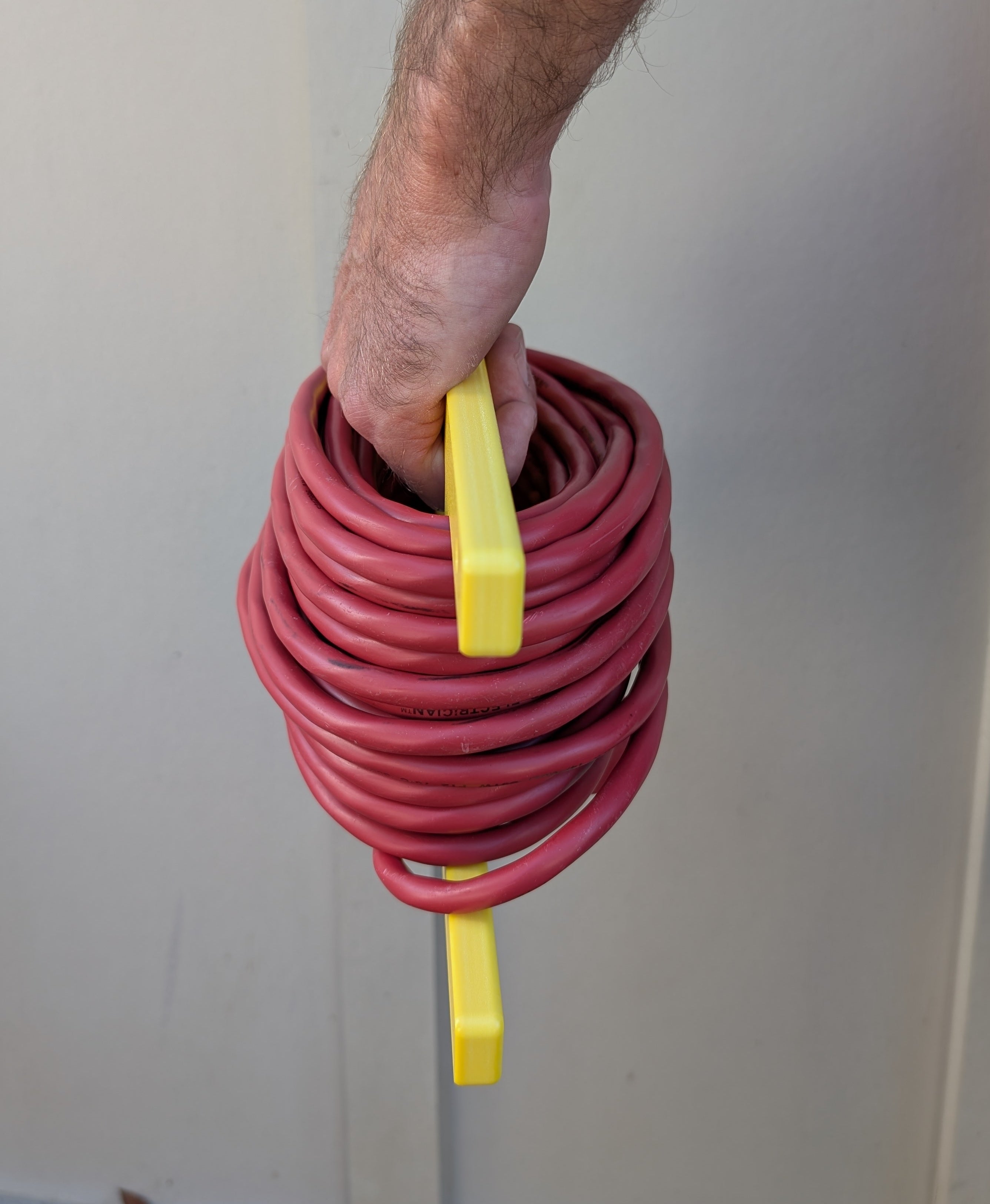 Yellow HDPE extension cord reel holder for 100 ft cords by Cauff